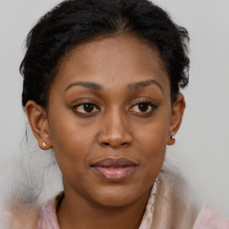 Joyful black adult female with medium  brown hair and brown eyes