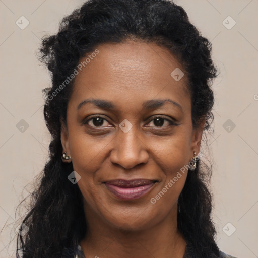 Joyful black young-adult female with long  brown hair and brown eyes