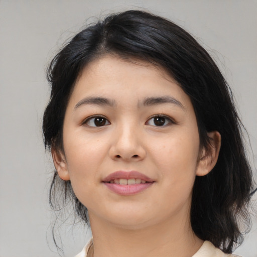 Joyful asian young-adult female with medium  black hair and brown eyes