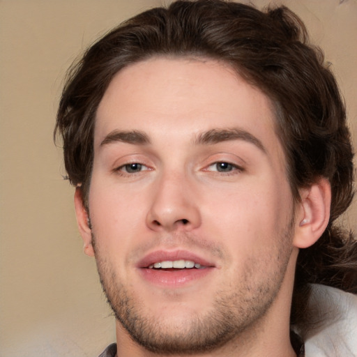 Joyful white young-adult male with medium  brown hair and brown eyes