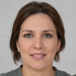 Joyful white adult female with medium  brown hair and brown eyes