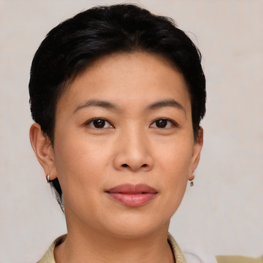 Joyful asian young-adult female with short  black hair and brown eyes