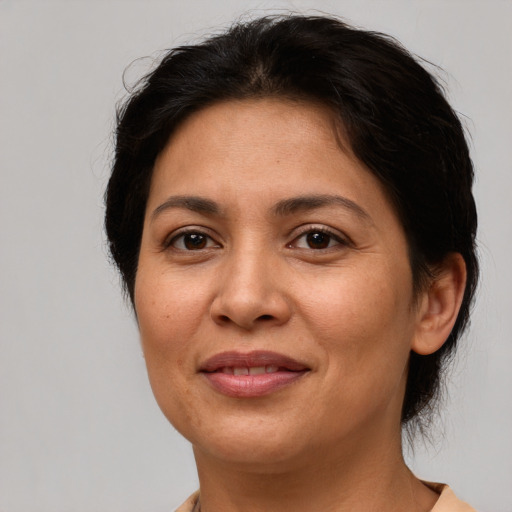 Joyful latino adult female with short  brown hair and brown eyes