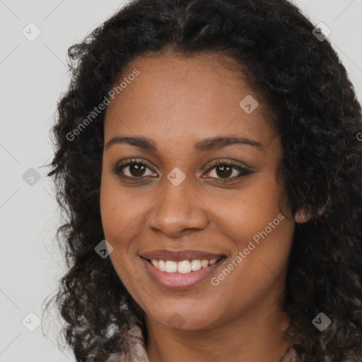 Joyful black young-adult female with long  brown hair and brown eyes