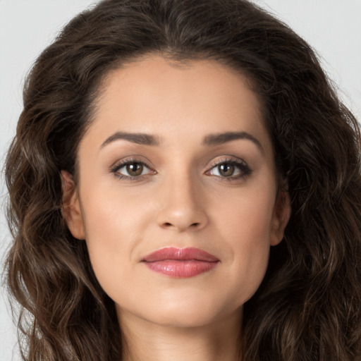 Joyful white young-adult female with long  brown hair and brown eyes