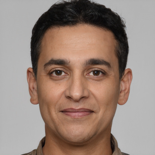 Joyful white adult male with short  black hair and brown eyes