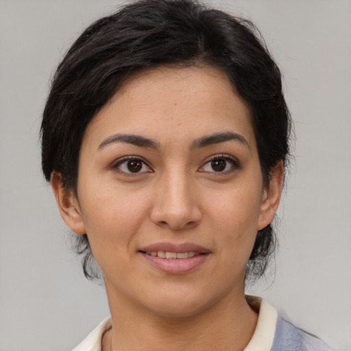 Joyful latino young-adult female with medium  brown hair and brown eyes