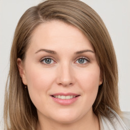 Joyful white young-adult female with long  brown hair and blue eyes