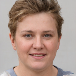 Joyful white young-adult female with short  brown hair and grey eyes