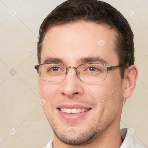 Joyful white young-adult male with short  brown hair and brown eyes