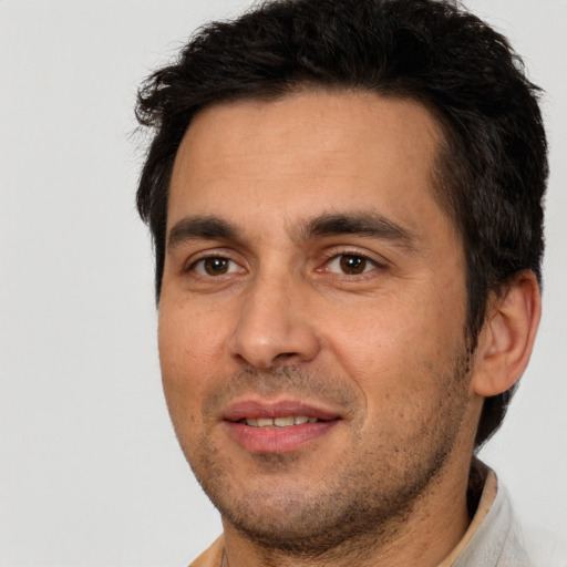 Joyful white young-adult male with short  black hair and brown eyes
