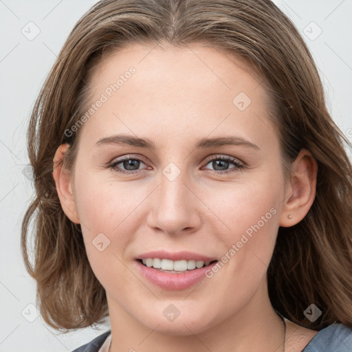 Joyful white young-adult female with medium  brown hair and blue eyes