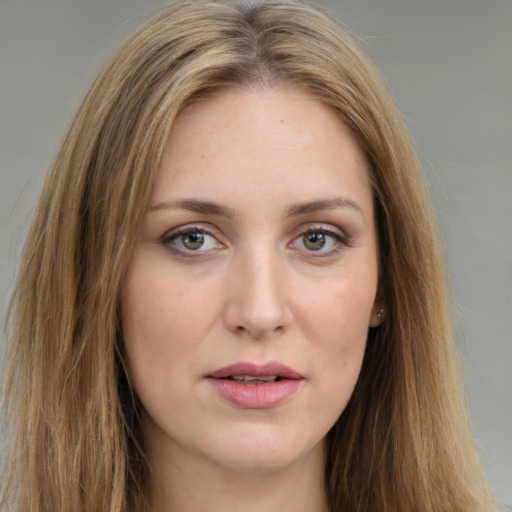 Joyful white young-adult female with long  brown hair and green eyes