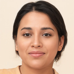 Joyful latino young-adult female with medium  brown hair and brown eyes