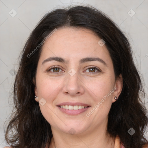 Joyful white adult female with long  brown hair and brown eyes