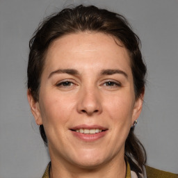 Joyful white adult female with medium  brown hair and brown eyes