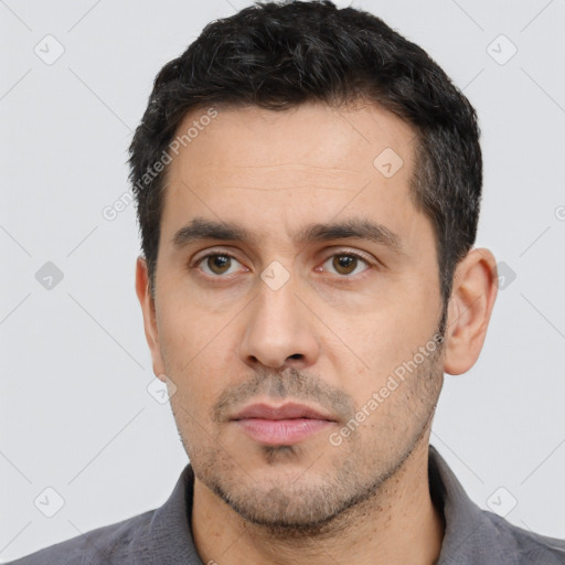 Neutral white adult male with short  black hair and brown eyes