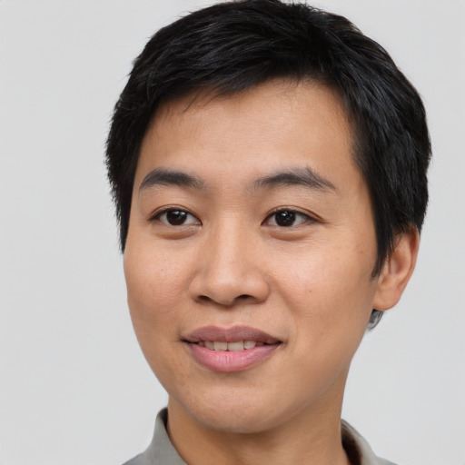 Joyful asian young-adult male with short  brown hair and brown eyes