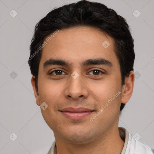 Joyful white young-adult male with short  black hair and brown eyes