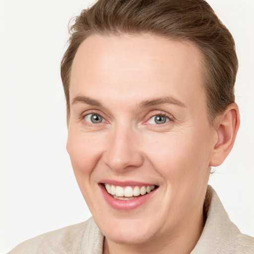 Joyful white adult female with short  brown hair and grey eyes