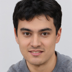 Joyful asian young-adult male with short  black hair and brown eyes