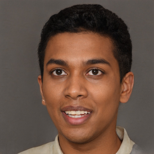 Joyful black young-adult male with short  black hair and brown eyes