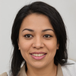 Joyful latino young-adult female with medium  brown hair and brown eyes