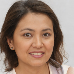 Joyful white young-adult female with medium  brown hair and brown eyes