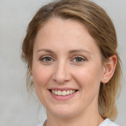 Joyful white young-adult female with medium  brown hair and blue eyes