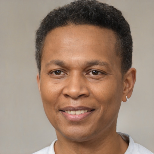 Joyful latino adult male with short  brown hair and brown eyes