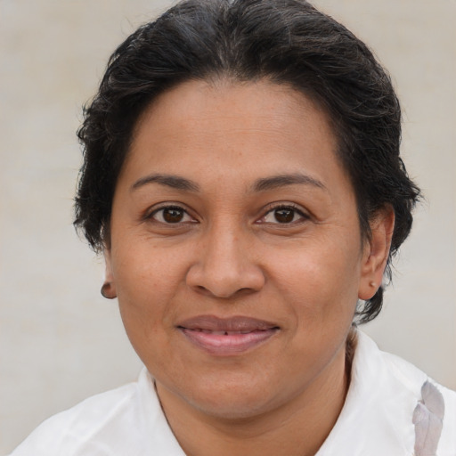 Joyful latino adult female with short  brown hair and brown eyes