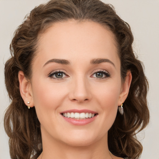 Joyful white young-adult female with long  brown hair and green eyes