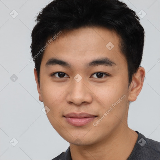 Joyful asian young-adult male with short  black hair and brown eyes