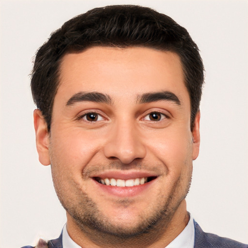 Joyful white young-adult male with short  black hair and brown eyes