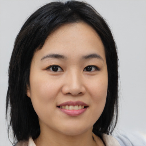 Joyful asian young-adult female with medium  black hair and brown eyes