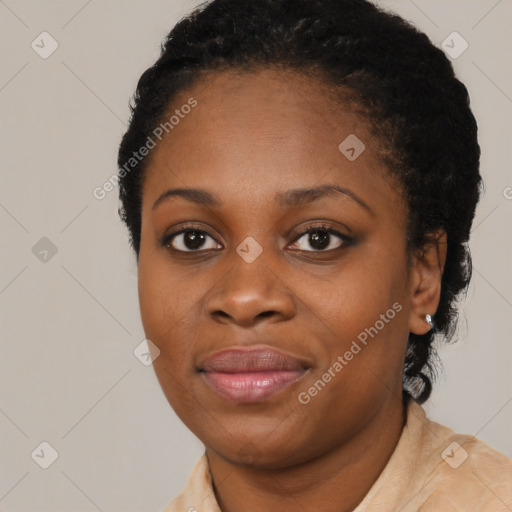 Joyful black young-adult female with short  black hair and brown eyes