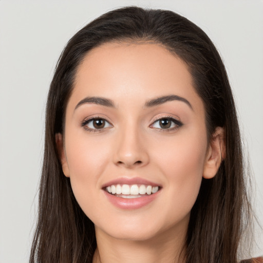 Joyful white young-adult female with long  brown hair and brown eyes