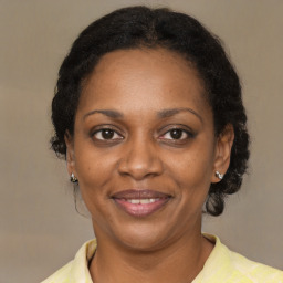 Joyful black adult female with short  brown hair and brown eyes