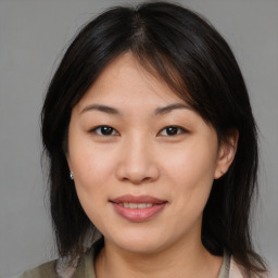 Joyful asian young-adult female with medium  brown hair and brown eyes