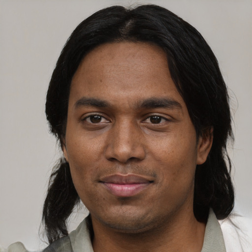 Joyful black adult male with medium  black hair and brown eyes