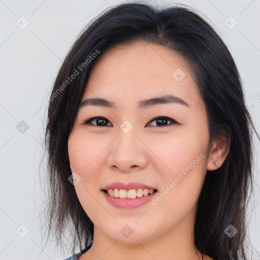 Joyful asian young-adult female with long  brown hair and brown eyes