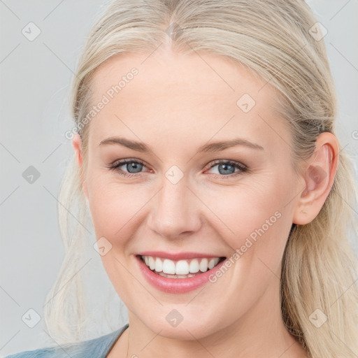 Joyful white young-adult female with long  brown hair and blue eyes