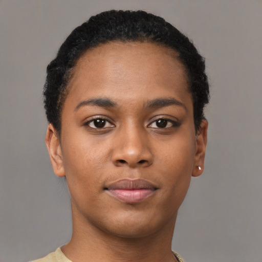 Joyful black young-adult female with short  black hair and brown eyes