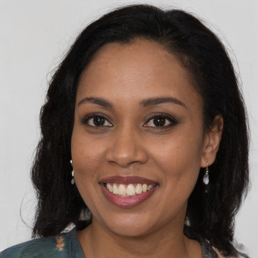 Joyful black young-adult female with medium  brown hair and brown eyes
