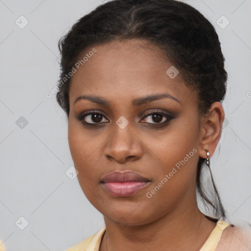 Joyful black young-adult female with short  brown hair and brown eyes