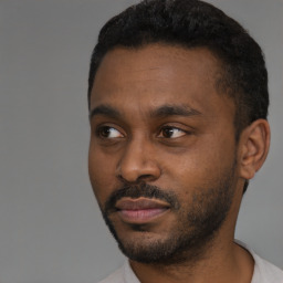 Joyful black young-adult male with short  black hair and brown eyes