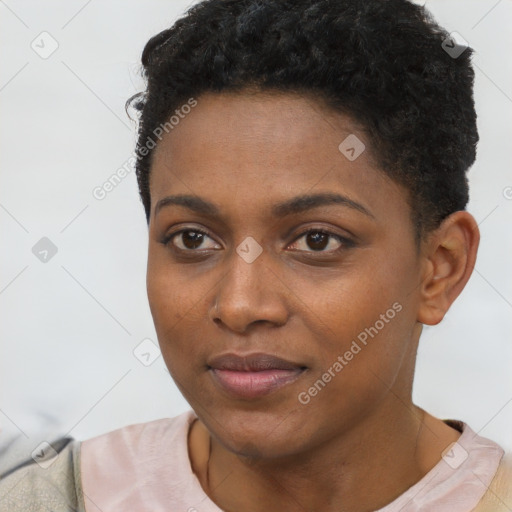 Joyful black young-adult female with short  black hair and brown eyes