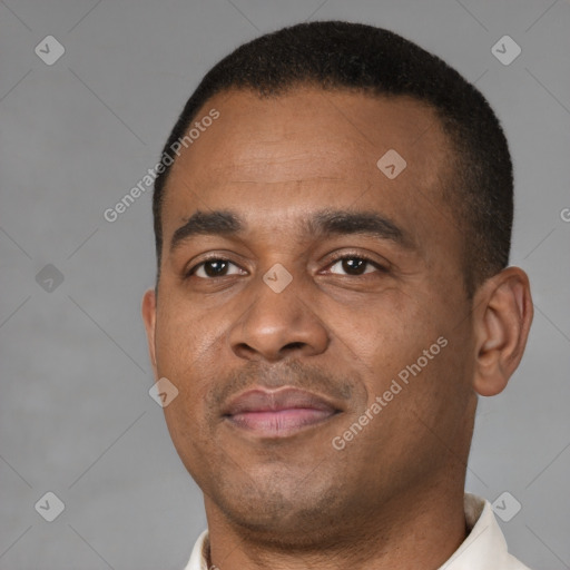 Joyful latino young-adult male with short  brown hair and brown eyes