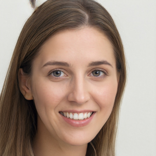 Joyful white young-adult female with long  brown hair and grey eyes