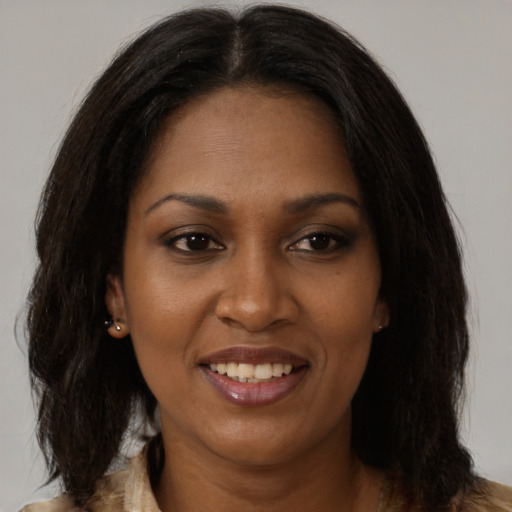 Joyful black young-adult female with medium  brown hair and brown eyes
